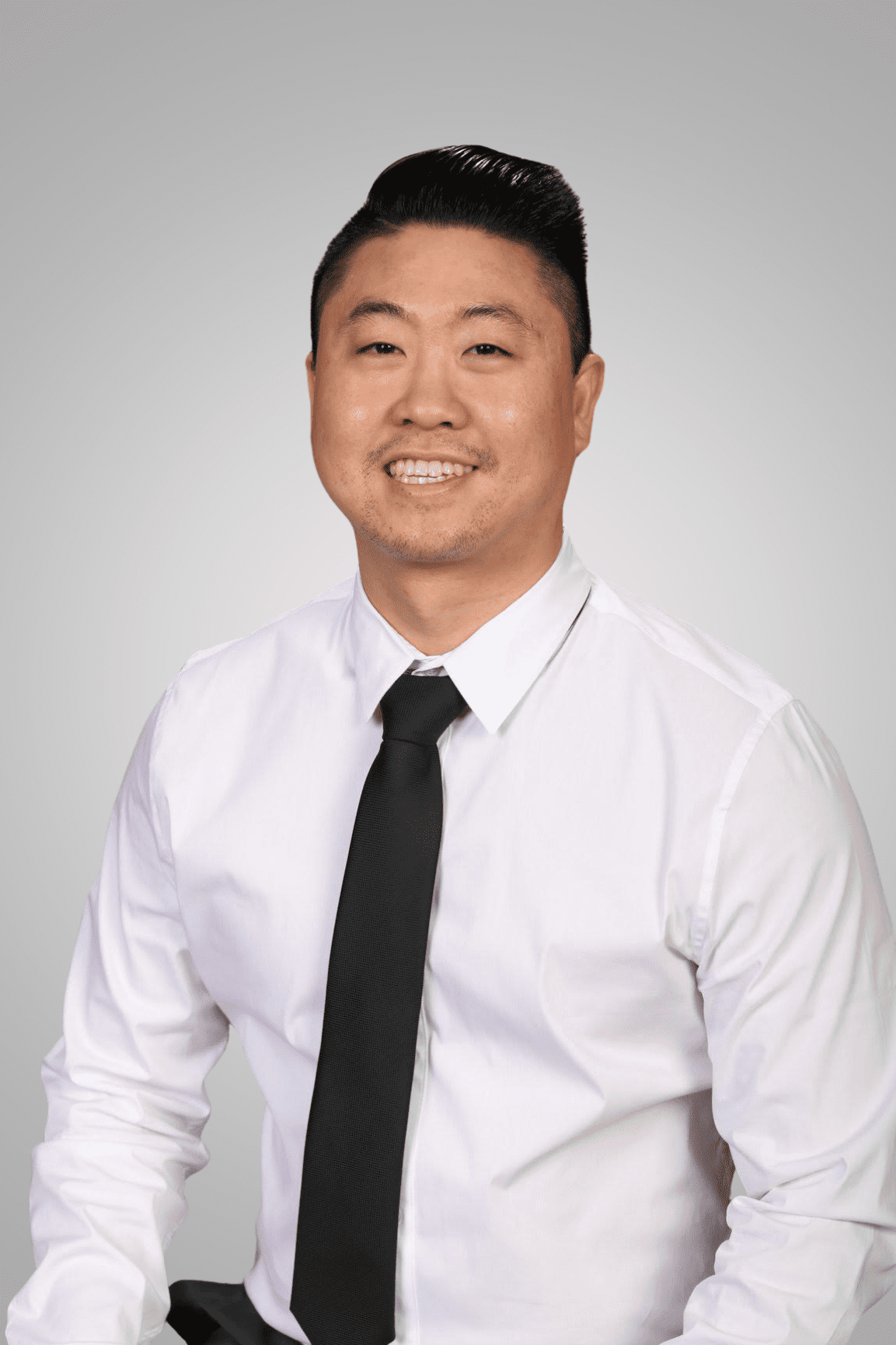 Addison, TX dental implants dentist Dr. Lee smiles for a professional photo